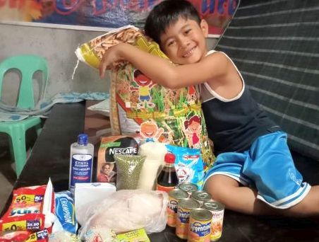 This boy beneficiary's smile upon receiving food and pandemic essentials is priceless