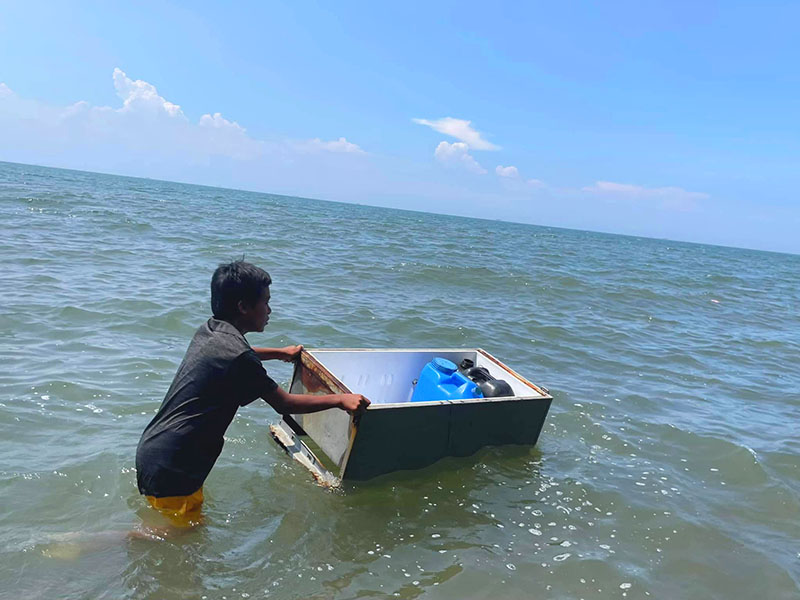 One of our beneficiaries in Noveleta with his makeshift vessel to fetch drinking water.