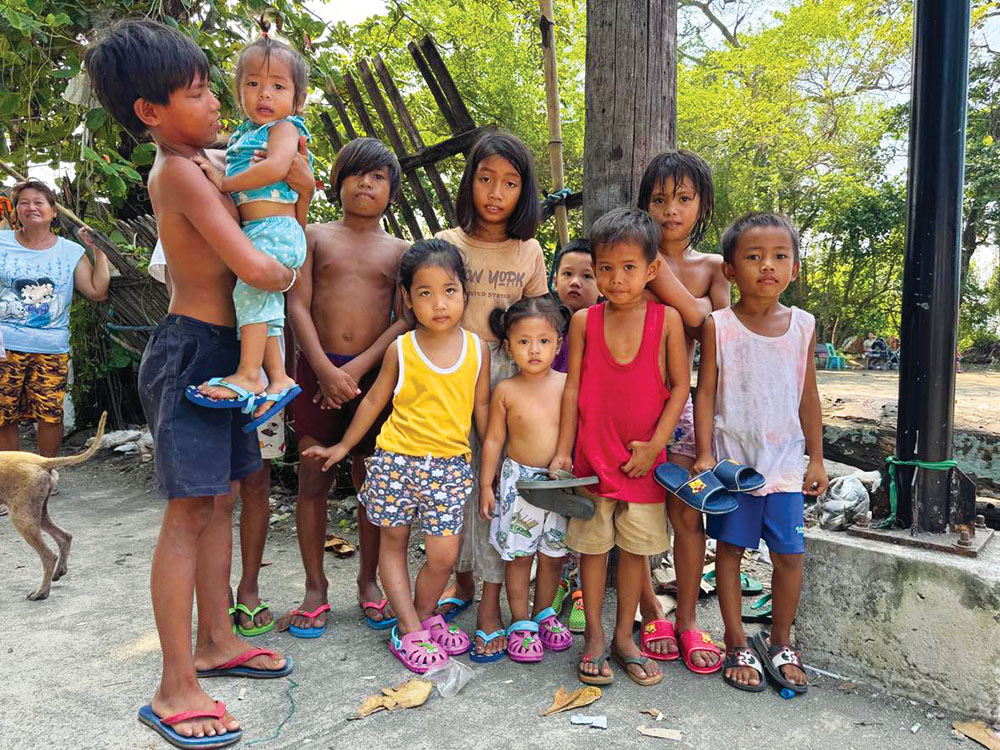 Children who benefited from donated slippers from Italy.