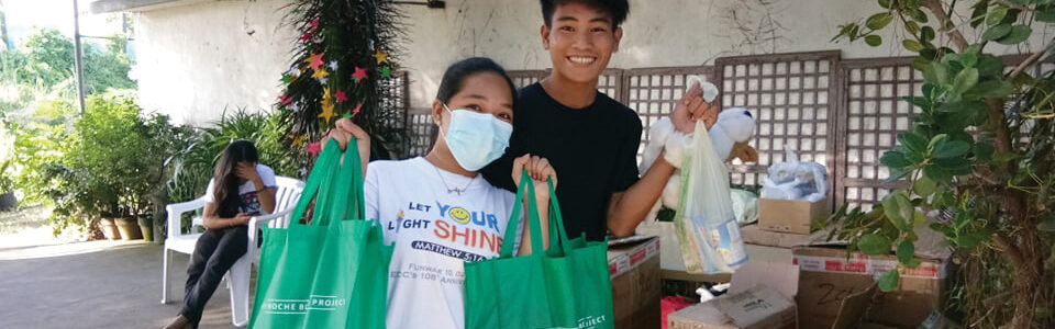 Our youth in Noveleta enjoy distributing The Noche Buena Project Christmas bags.